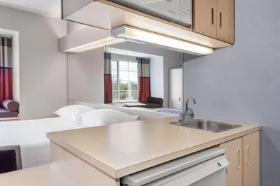 a kitchen with a sink and a couch in a room at Microtel Inn & Suites Modesto in Ceres