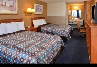 a hotel room with two beds and a desk at Americas Best Value Inn - Carson City in Carson City