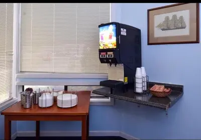 a room with a table and a television on a wall at Americas Best Value Inn - Carson City in Carson City