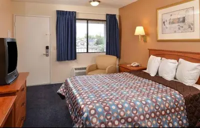 a hotel room with a bed and a television at Americas Best Value Inn - Carson City in Carson City