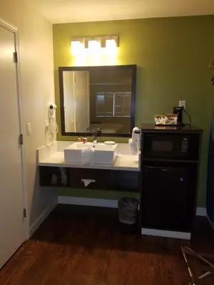 a bathroom with a sink and a large mirror at Baymont by Wyndham Modesto Salida in Modesto