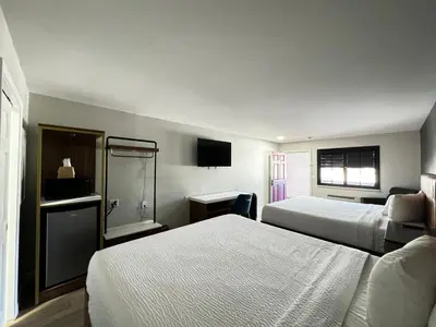 a hotel room with two beds and a television at SureStay by Best Western Morgan Hill in Morgan Hill