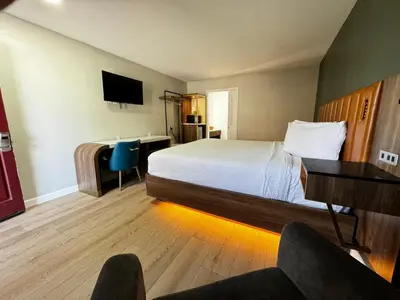 a hotel room with a bed and a desk at SureStay by Best Western Morgan Hill in Morgan Hill