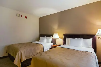 a hotel room with two beds and two lamps at Quality Inn Fresno Yosemite Airport in Fresno
