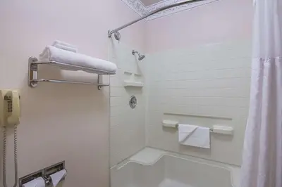 a bathroom with a shower and a tub and a toilet at Quality Inn Fresno Yosemite Airport in Fresno
