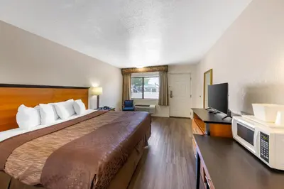 a hotel room with a bed and a television at Rodeway Inn at Nevada State Capitol in Carson City