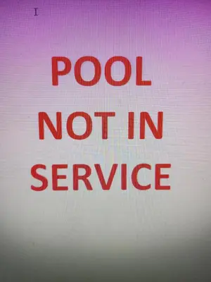 a red sign that sayspool not in service at University Square Hotel in Fresno
