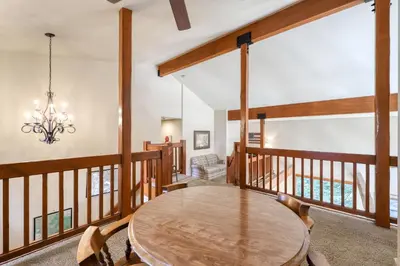 a dining room with a wooden table and a chandelier at Alderhill in Shaver Lake