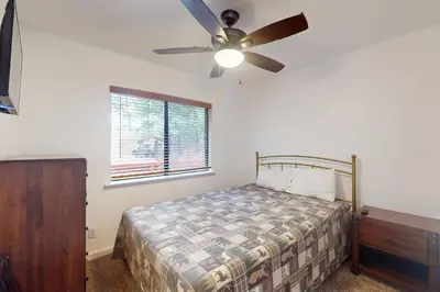 a bedroom with a bed and a ceiling fan at Deaver's Place in Shaver Lake