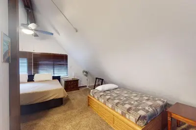a bedroom with two beds and a window in it at Deaver's Place in Shaver Lake