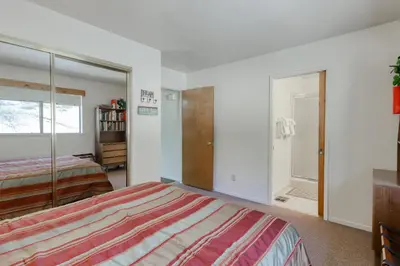 a bedroom with a bed and a mirror at Eagle's Landing Condo 68 in Lakeshore