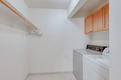 a laundry room with a washer and dryer in it at Eagle's Landing Condo 68 in Lakeshore