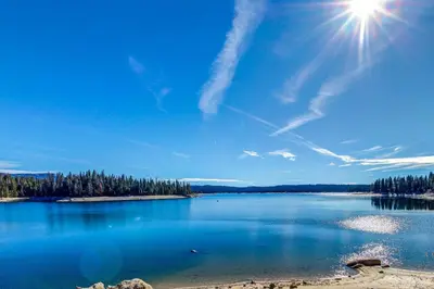 a view of a lake with the sun in the sky at Eagle's Landing Condo 68 in Lakeshore