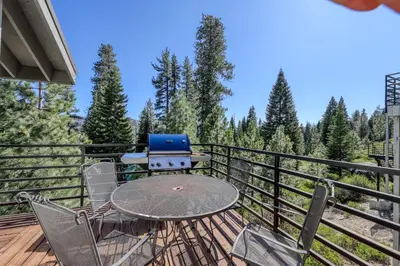 a patio with a table and chairs on a deck at Eagle's Landing Condo 68 in Lakeshore