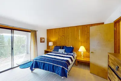 a bedroom with a bed and a large window at Eagle's Landing Condo 78 in Lakeshore