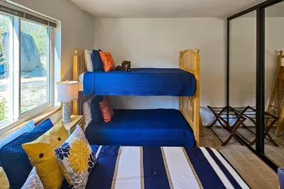 a room with two bunk beds and a couch at Eagle's Landing Condo 78 in Lakeshore