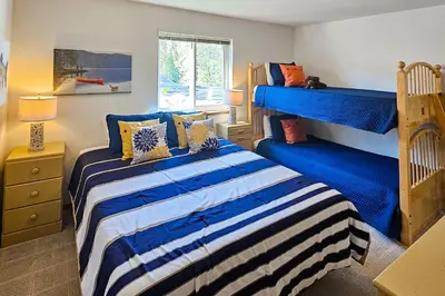 a bedroom with two beds and a bunk bed at Eagle's Landing Condo 78 in Lakeshore