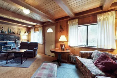a living room with a couch and a table at Foxtail Delight in Dora Belle
