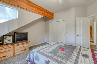 a bedroom with a bed and a tv at Hatcher's Hideaway in Shaver Lake