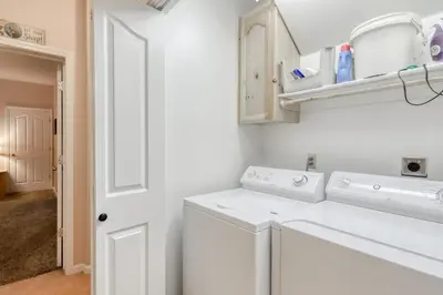 a white laundry room with a washer and dryer at Hatcher's Hideaway in Shaver Lake