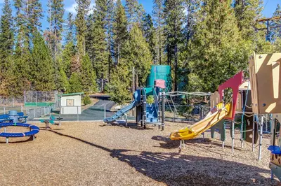 a park with a playground with a slide at Huntington Lake Condo 92 in Lakeshore