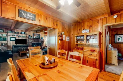 a dining room with a wooden table in a house at Mountain Memories in Shaver Lake