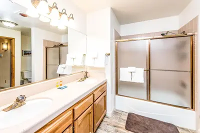 a bathroom with a sink and a shower at Paw's Cabin in Shaver Lake
