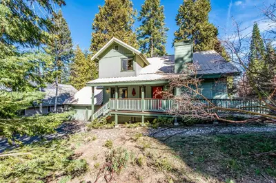 a house on a hill with trees at Paw's Cabin in Shaver Lake