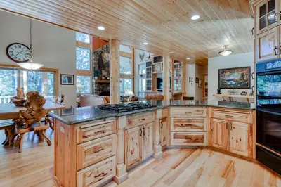 a kitchen with wooden cabinets and a large island at Pinnacle Point in Shaver Lake