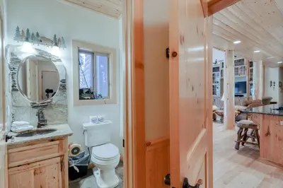 a bathroom with a toilet and a sink and a mirror at Pinnacle Point in Shaver Lake
