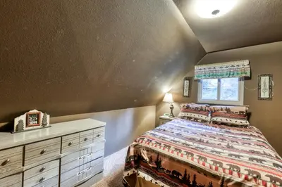a bedroom with a bed and a dresser and a window at The Limit in Dora Belle