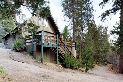 a house in the woods with a balcony at The Limit in Dora Belle
