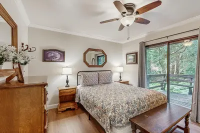 a bedroom with a bed and a ceiling fan at Water's Edge Retreat in Shaver Lake