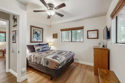a bedroom with a bed and a ceiling fan at Water's Edge Retreat in Shaver Lake