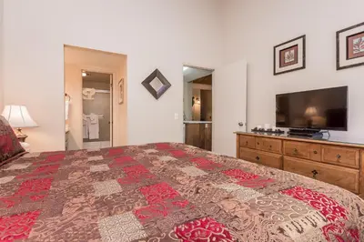 a bedroom with a large bed and a flat screen tv at Crestview -B # 46 in Mammoth Lakes