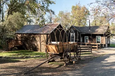 a wooden horse drawn carriage in front of a building at Historic Sonora Inn in Sonora