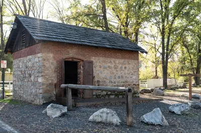 a small brick building with a gate and rocks at Historic Sonora Inn in Sonora