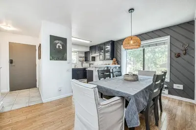a kitchen and dining room with a table and chairs at Huntington Lake Condo 115 in Lakeshore