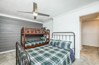 a bedroom with a bed and a ceiling fan at Huntington Lake Condo 115 in Lakeshore