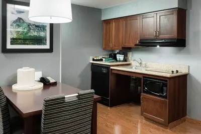 a small kitchen with a table and a microwave at Homewood Suites by Hilton Fresno Airport/Clovis in Clovis