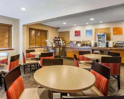 a restaurant with tables and chairs and a kitchen at Quality Inn Lone Pine near Mount Whitney in Lone Pine