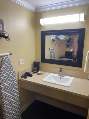 a bathroom with a sink and a mirror at Timberline Motel in Lone Pine