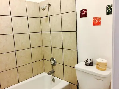 a bathroom with a toilet and a shower and a sink at Maple Inn and Suites Los Banos in Los Banos