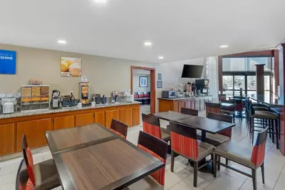 a restaurant with tables and chairs and a counter at Comfort Inn & Suites Rocklin - Roseville in Rocklin