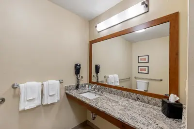 a bathroom with a sink and a large mirror at Comfort Inn & Suites Rocklin - Roseville in Rocklin