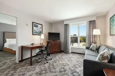 a hotel room with a desk and a bed at Homewood Suites by Hilton Sacramento/Roseville in Roseville