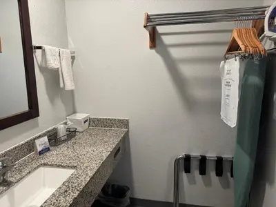 a bathroom with a sink and a mirror at Travelodge by Wyndham Sacramento / Rancho Cordova in Sacramento