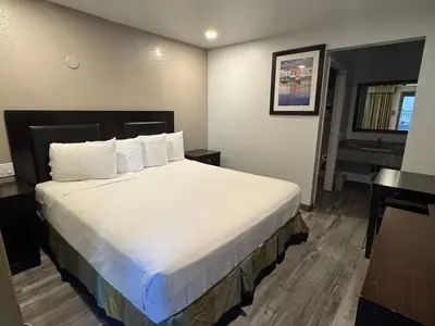 a bedroom with a large bed in a hotel room at Travelodge by Wyndham Sacramento / Rancho Cordova in Sacramento