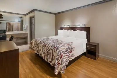 a hotel room with a bed and a kitchen at Red Roof Inn Stockton in Stockton