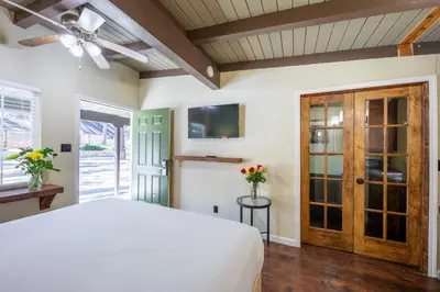 a bedroom with a bed and a ceiling fan at Emerald Bay Lodge in South Lake Tahoe